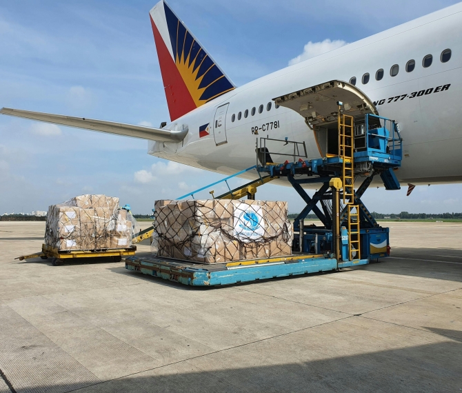 Cargo being loaded onto a commercial airplane at an airport in Ho Chi Minh City, Vietnam.